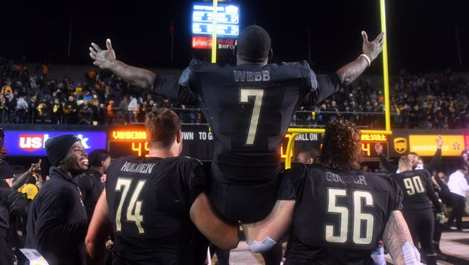 Vanderbilt running back Ralph Webb (7) is carried off the field by offensive linemen Will Holden (74) and Barrett Gouger (56) following a win over Tennessee.