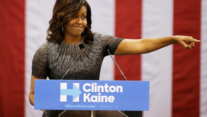 First lady Michelle Obama reacts to a supporter's words during her address to the Arizona Democratic Party Early Vote rally at the Phoenix Convention Center on Thursday, Oct. 20, 2016. Obama is campaigning for Democratic presidential nominee Hillary Clinton.