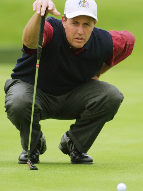 Phil Mickelson lines up a putt on the second green, during a match with David Toms during the Ryder Cup at The Belfry, Sutton Coldfield, England, on Sept. 27, 2002. Mickelson and Toms went on to win the match.