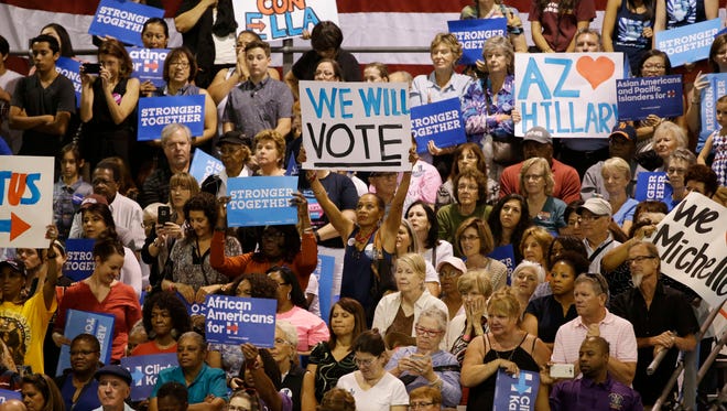 Supporters watch first lady Michelle Obama address the Arizona Democratic Party Early Vote rally at the Phoenix Convention Center on Thursday, Oct. 20, 2016.
