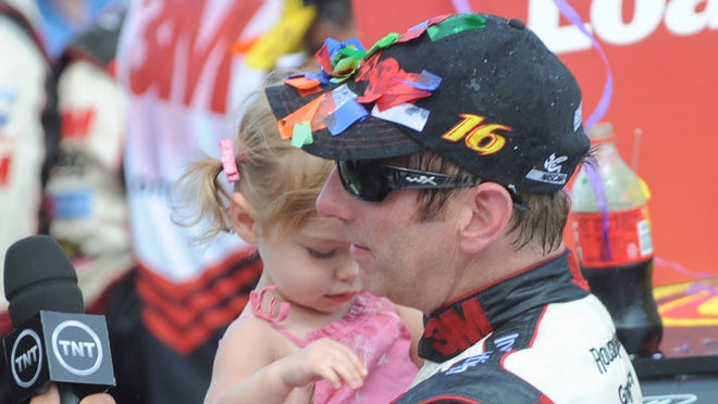 Greg Biffle and his daughter Emma after Biffle won the Quicken Loans 400 at Michigan International Speedway. The win, his sole victory of 2013, helped Biffle secure a place in the Chase.