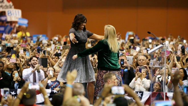 First lady Michelle Obama hugs Barry Goldwater’s granddaughter Carolyn Goldwater Ross after she endorsed Hillary Clinton at the Arizona Democratic Party Early Vote rally at the Phoenix Convention Center on Thursday, Oct. 20, 2016.  Michelle Obama is campaigning for Democratic presidential nominee Hillary Clinton.
