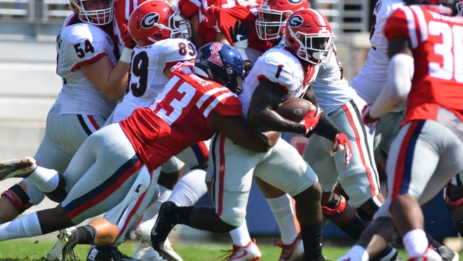 Georgia running back Sony Michel is hit by Mississippi linebacker Detric Bing-Dukes during the first quarter at Vaught-Hemingway Stadium.