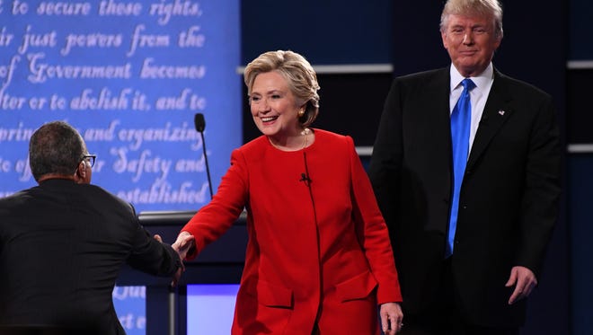 Democratic presidential candidate Hillary Clinton shakes hands with moderator Lester Holt from NBC after the conclusion of the debate.