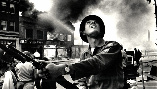 National Guardsman Gary Ciko checks on buildings for snipers on the first day of the 1967 riot in Detroit, Michigan.