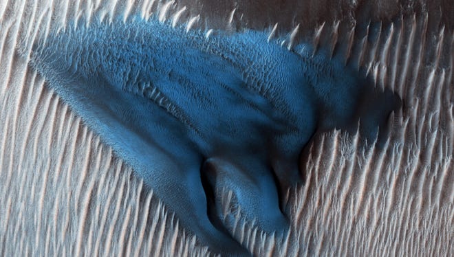 Sand dunes often accumulate in the floors of craters. In this region of Lyot Crater, NASA's Mars Reconnaissance Orbiter (MRO) shows a field of classic barchan dunes on Jan. 24, 2018.