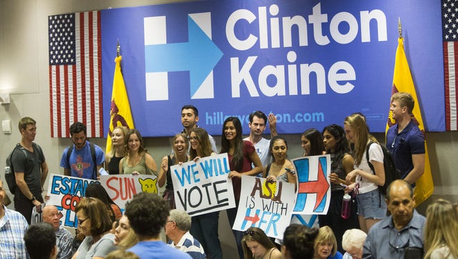 Students hold signs before Chelsea Clinton stumps for her mom, Democratic presidential nominee Hillary Clinton, at Arizona State University in Tempe on Oct. 19, 2016.