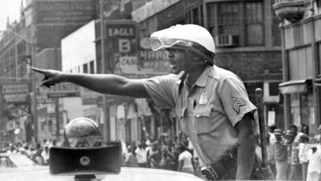 A police officer gives instructions during the riots in1967 in Detroit.