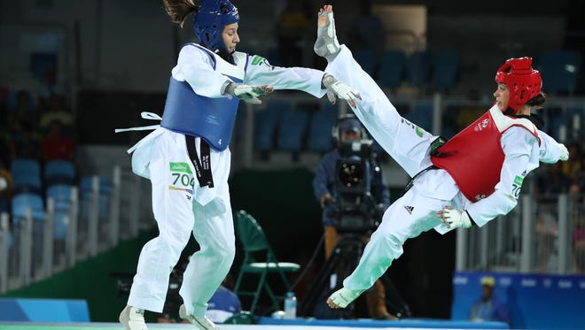 Jackie Galloway of the United States pushes Reshmie Shari Oogink of the Netherlands during the women's +67kg taekwondo quarterfinals during the Rio 2016 Summer Olympic Games at Carioca Arena 3.