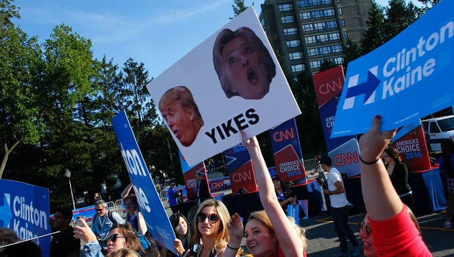Students hold banners before the start of the first presidential debate between Hillary Clinton and Donald Trump at Hofstra University.