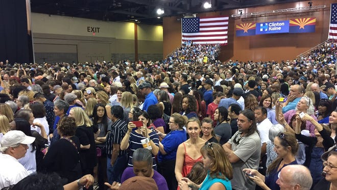 People wait excitedly for Michelle Obama as she's en route to the Phoenix Convention Center on Oct. 20, 2016.