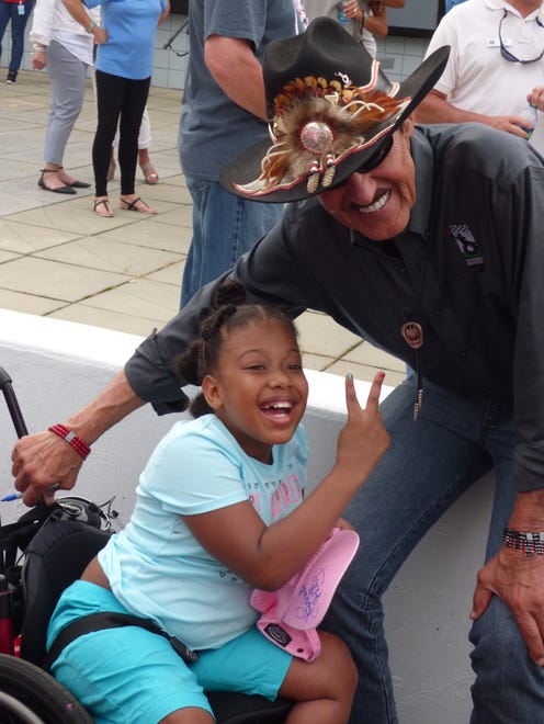 Richard Petty poses with a camper on a June 2017 visit to Victory Junction Gang Camp.