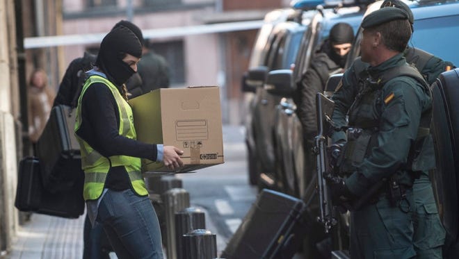 Members of the Spanish civil guard remove items on Feb. 14 from the home of an Algerian national arrested in relation to jihadist links in Bilbao, Spain.