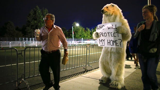 An activist dressed up as a polar bear walks outside before the start of the first presidential debate between Hillary Clinton and Donald Trump at Hofstra University.