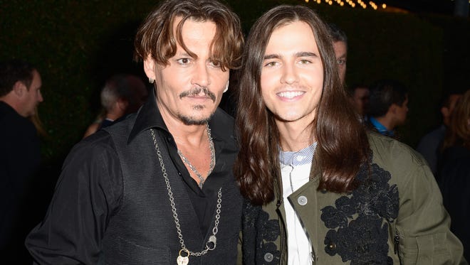 Johnny Depp (L) and Anthony De La Torre, who plays a young Captain Jack Sparrow in 'Dead Mean Tell No Tales,' pose together.