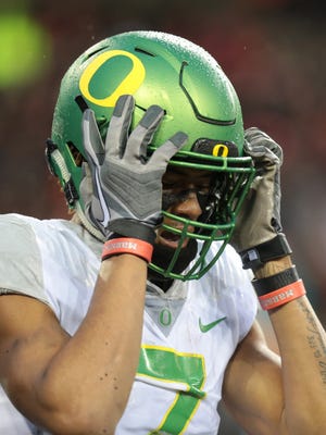 Oregon Ducks wide receiver Darren Carrington II grabs his helmet at the end of a game against the Oregon State Beavers.