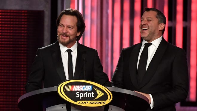Musician Eddie Vedder, left, honors retiring NASCAR driver Tony Stewart during the 2016 NASCAR Sprint Cup Series Awards, Dec. 2 in Las Vegas.