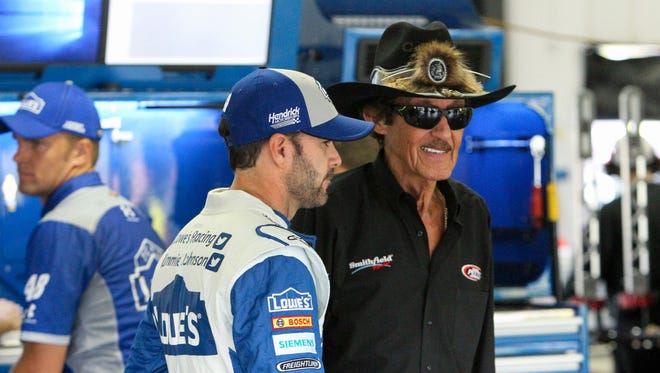 Richard Petty, right, talks with driver Jimmie Johnson on July 29, 2016. Later that year, Johnson would tie Petty and Dale Earnhardt Sr. with seven NASCAR Cup Series championships.