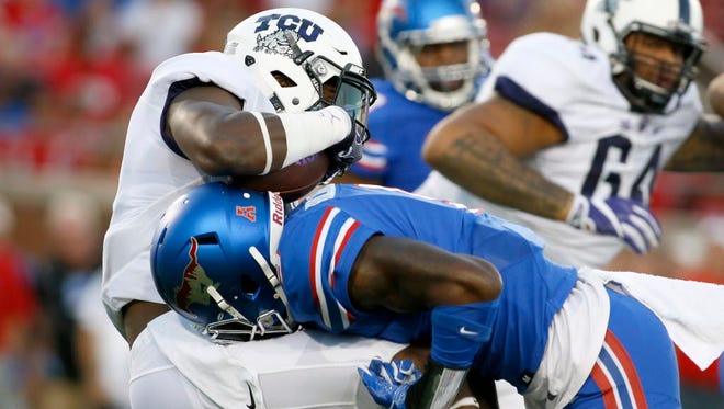 TCU wide receiver John Diarse (9) is tackled by Southern Methodist defensive back Horace Richardson (9) in the first quarter.