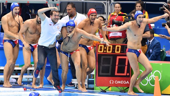 Team Serbia celebrates winning the gold medal against Croatia in the men's water polo event during the Rio 2016 Summer Olympic Games at Olympic Aquatics Stadium.