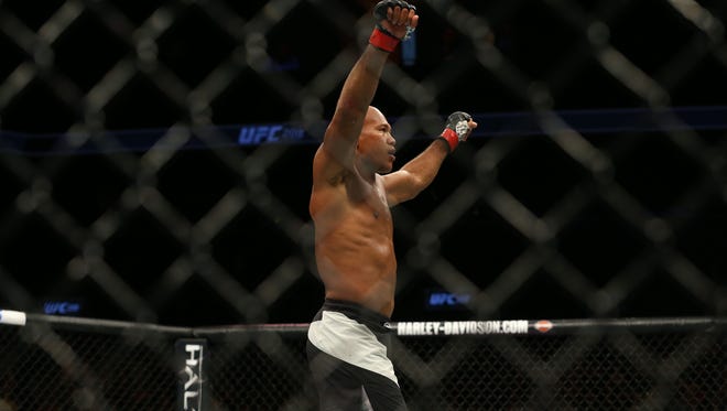Jacare Souza (red gloves) raises his arms in victory after defeating Tim Boetsch (blue gloves) (not pictured) during UFC 208 at Barclays Center.
