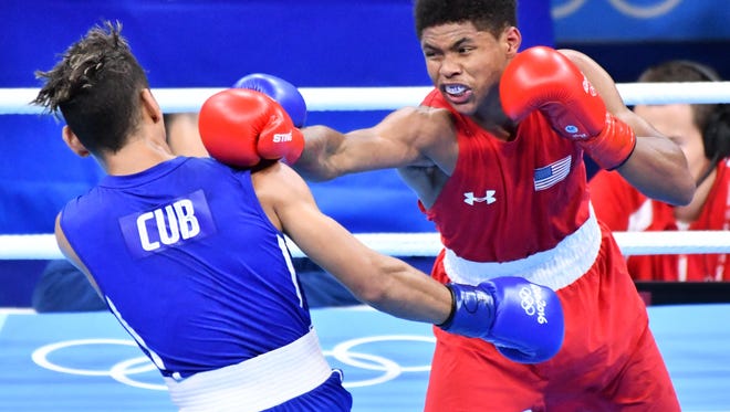 Shakur Stevenson of the United States throws a punch against Robeisy Ramirez of Cuba during their men's bantamweight gold medal bout at the Rio 2016 Summer Olympic Games at Riocentro - Pavilion 6.