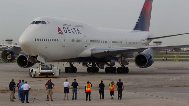 The first Boeing 747-400 ever owned by Delta Air Lines is towed across a road to its new home at the Delta Museum adjacent to the Atlanta airport on April 30, 2016.