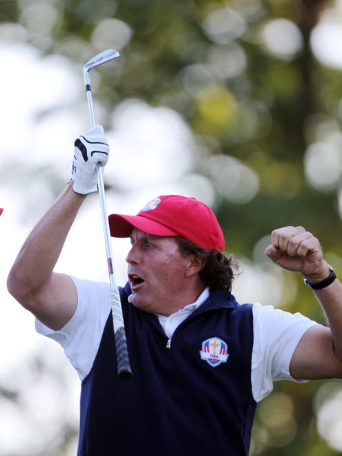 In 2012 Phil Mickelson celebrates on the 17th tee box after hitting his tee shot close to the pin to win the afternoon match during the 39th Ryder Cup at Medinah Country Club.