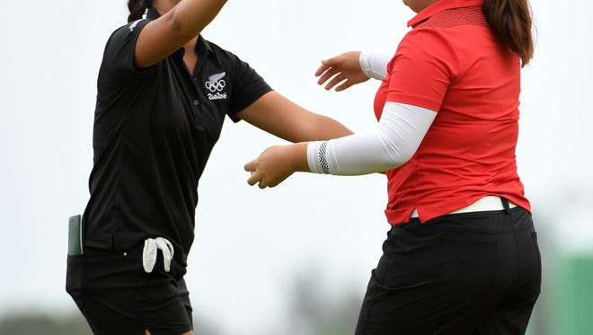 Inbee Park of South Korea, right, gets congratulations from Lydia Ko of New Zealand after winning gold in the final round of women's golf during the Rio 2016 Summer Olympic Games at Olympic Golf Course.