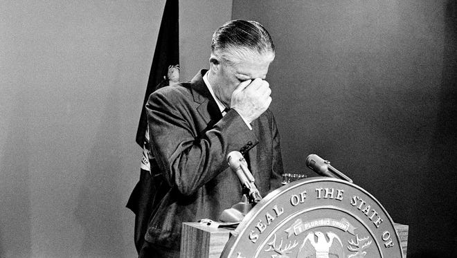 Michigan Governor George Romney bows head with hand to forehead in a moment of meditation before making a live television appearance to speak on Detroit's rioting of past week, July 30, 1967. Romney said, "Both white and Negro extremist organizations are preaching hate and arming."