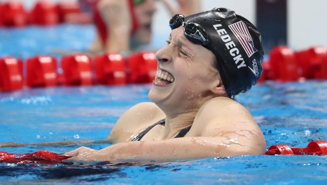 Katie Ledecky (USA) celebrates after winning the women's 800m freestyle final at Olympic Aquatics Stadium.