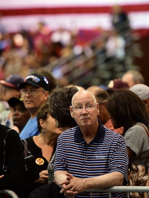 Nick Leech of Peoria, Ariz. sits in the crowd to hear Michelle Obama's speech at the Phoenix Convention Center on Oct. 20, 2016.