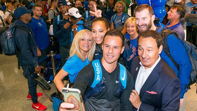 United Airlines CEO Oscar Munoz (front right) poses with U.S. Olympians at a send-off for the team at Houston Bush Intercontinental on Aug. 3, 2016.