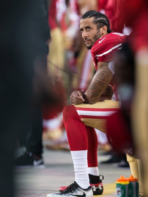 Kaepernick takes a knee during the anthem before the opener against the Rams.