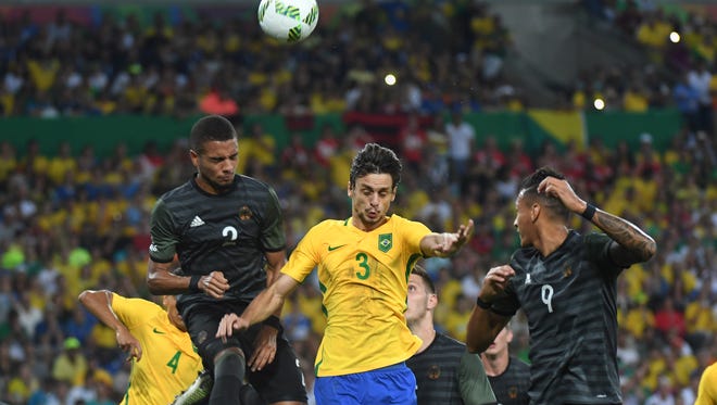 Brazil defender Rodrigo Caio (3) goes up for a header against Germany defender Jeremy Toljan (2) and forward Davie Selke (9) in the men's gold medal match during the Rio 2016 Summer Olympic Games at Maracana.