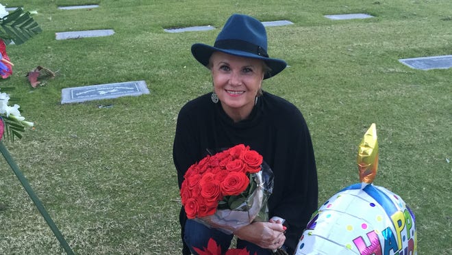 Frank Sinatra fans gather at Sinatra's grave on his 100th birthday at the Desert Memorial Park in Cathedral City on Saturday.