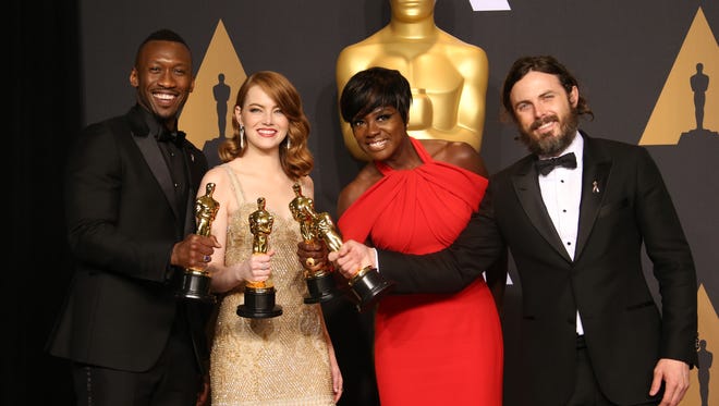 Oscar winners Mahershala Ali, left, winner of Best Supporting Actor for 'Moonlight,' Emma Stone, winner of Best Actress for 'La La Land,' Viola Davis, winner of the Best Supporting Actress award for 'Fences,' and Casey Affleck, winner of Best Actor for 'Manchester by the Sea,' in the trophy room during the 89th Academy Awards at Dolby Theatre.