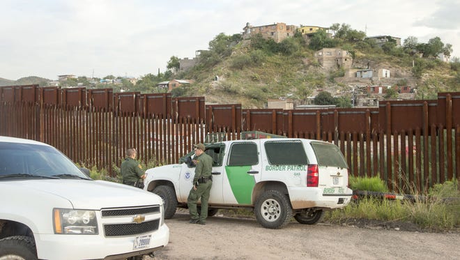 Border Patrol agents at the fence in Nogales, Ariz.