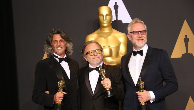 Christopher Nelson, left, Giorgio Gregorini, and Alessandro Bertolazzi pose with their Oscars for Achievement in Makeup and Hairstyling for 'Suicide Squad' in the trophy room during the 89th Academy Awards.