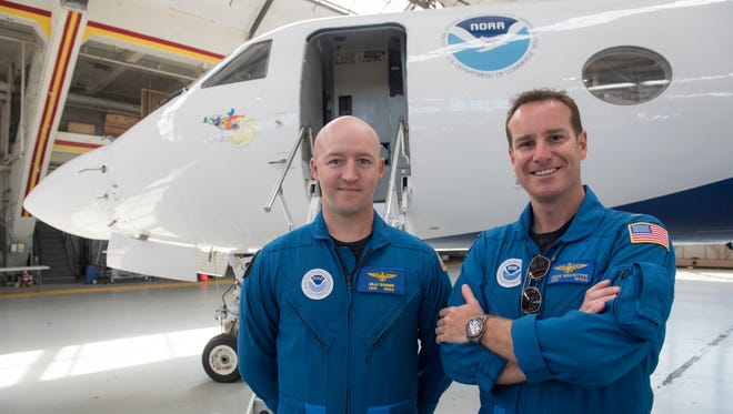 NOAA Aircraft Commander Doug Macintyre and Lt. Junior Grade Billy Bonner pose in front of "Gonzo," their Gulfstream IV research jet.