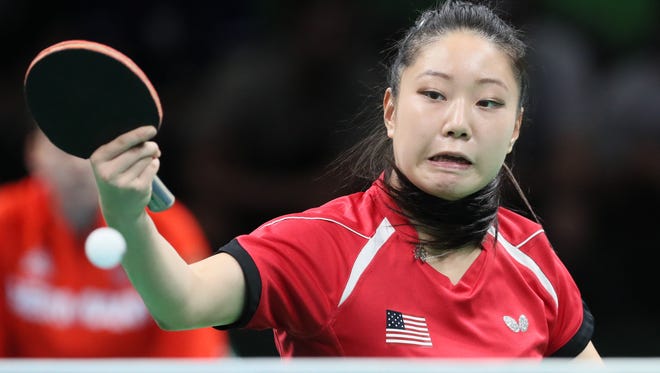 Lily Zhang of the United States competes against  Shan of Germany in a women's team first round table tennis contest at Riocentro - Pavilion 3 during the Rio 2016 Summer Olympic Games.