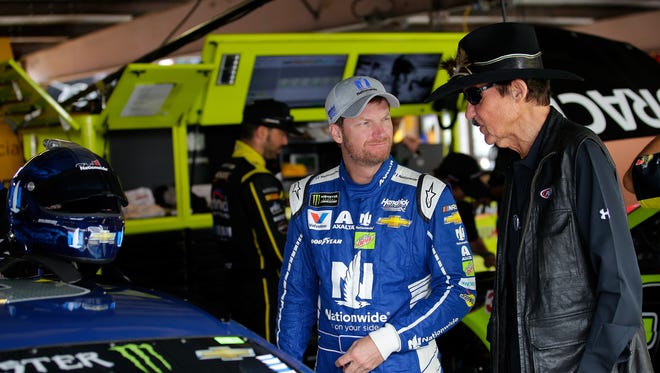 Richard Petty, right, talks with Dale Earnhardt Jr. at Dover International Speedway on June 3, 2017. Petty and Earnhardt's father, Dale Earnhardt Sr., each won seven NASCAR championships.