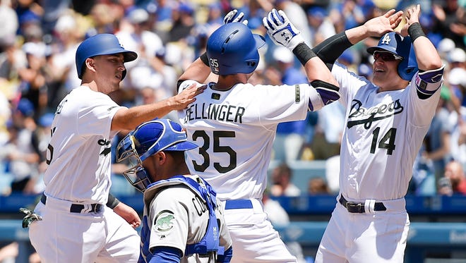 Cody Bellinger celebrates with Kiki Hernandez and Austin Barnes (left) after Hernandez hit a three-run home run against the Chicago Cubs.