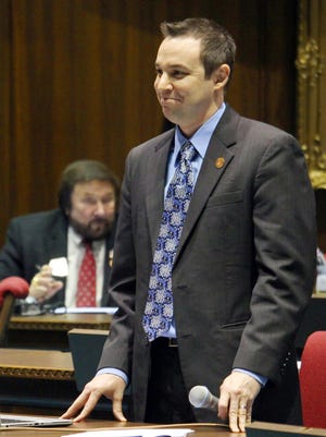 Arizona state Rep. J.D. Mesnard smiles Jan. 13, 2016, as he looks at the unanimous vote count on a revenge porn bill he sponsored, that makes it a crime to share nude photos of another person with intent to harm that person.