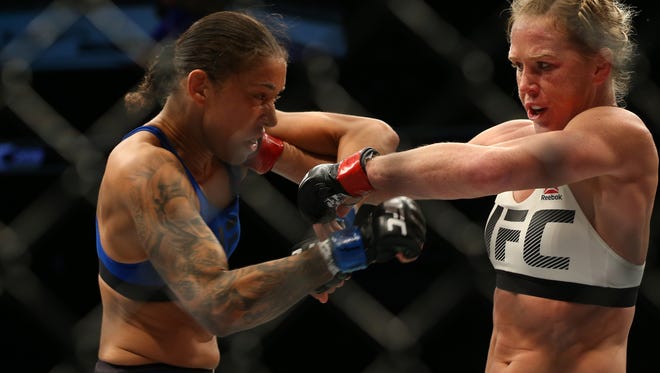Holly Holm (red gloves fights Germaine de Randamie (blue gloves) during UFC 208 at Barclays Center.