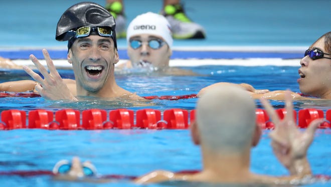 Michael Phelps reacts after finishing in a three-way tie for second in the men's 100-meter butterfly.