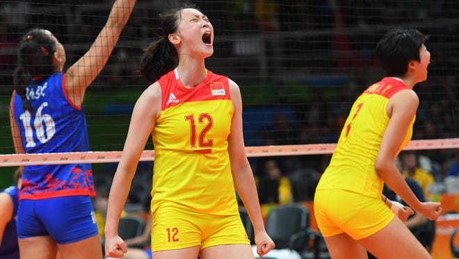 China wing spiker Ruoqi Hui (12) celebrates against Serbia in the women's volleyball gold medal match.