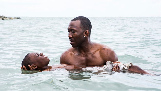 Alex Hibbert, foreground, and Mahershala Ali in a scene from the film, 'Moonlight.'