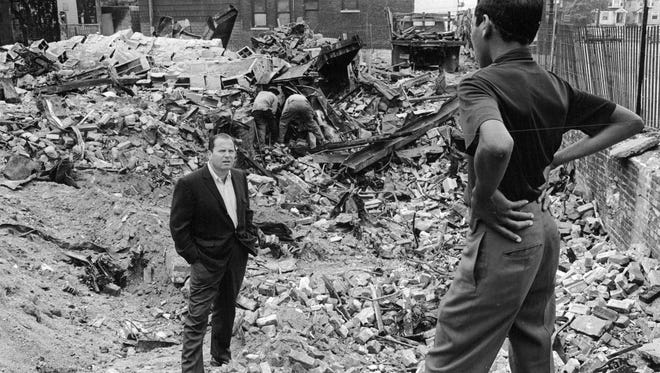 Detroit Mayor Jerome Cavanagh speaks to a young man on Detroit 's east side in September 1967 after the Detroit riots in July of 1967. The young man tells the mayor the rubble had been a five and ten cent store.