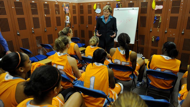 Summitt speaks to players after a game against George Washington.